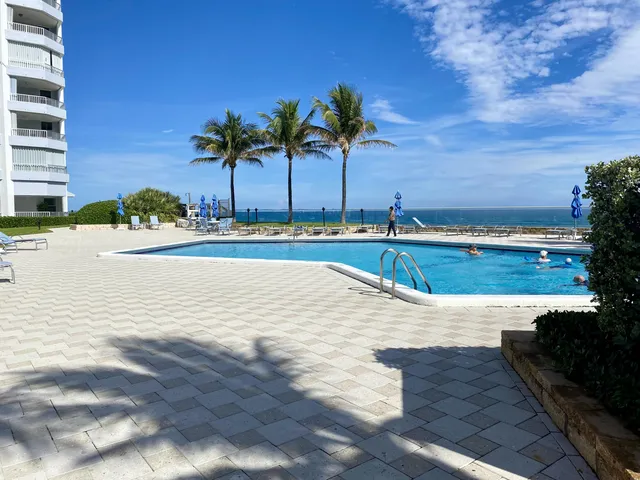 a room with furniture pool table and windows