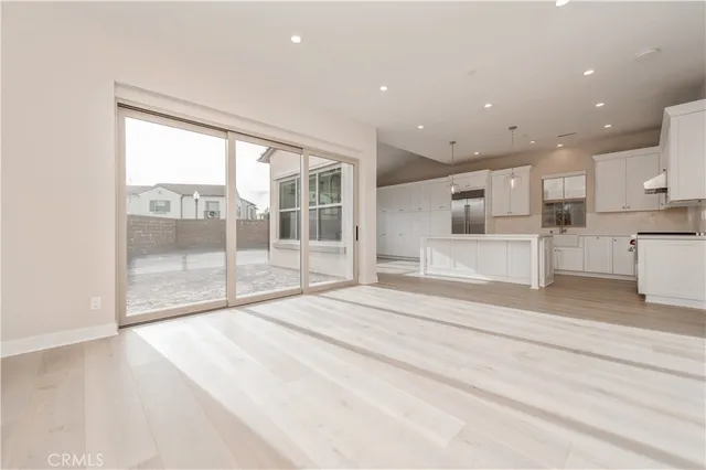 a large white kitchen with a large window
