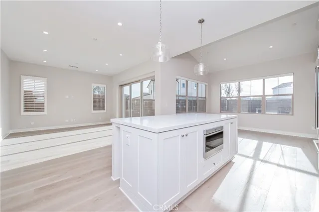 a kitchen with stainless steel appliances granite countertop a stove and a large window