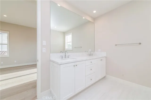 a bathroom with a sink double vanity and a mirror