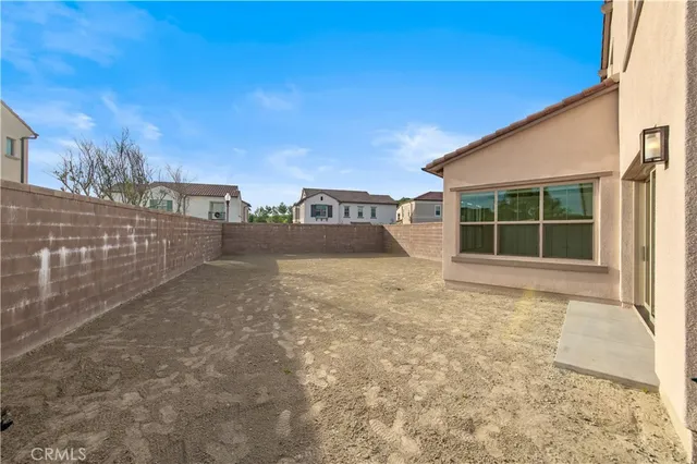 a view of a house with a large space and a car parked front of it