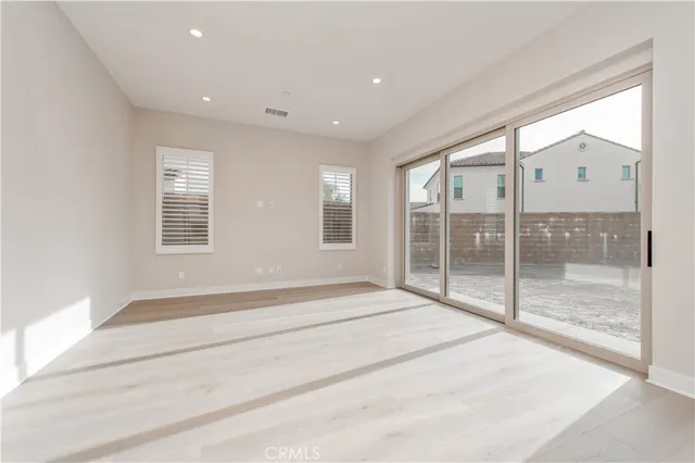 a view of an empty room with glass door