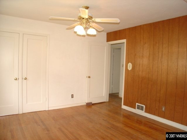 925 Whitaker Drive Reno, NV 89503 - Photo 4 of 9 a view of an empty room with wooden floor