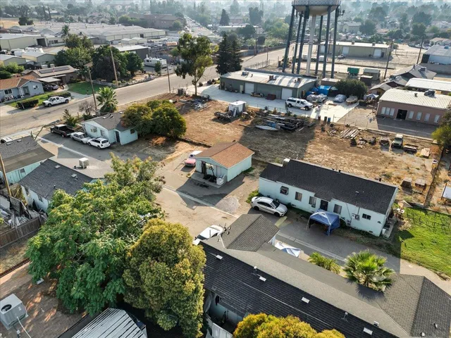 a view of a houses with yard from a balcony