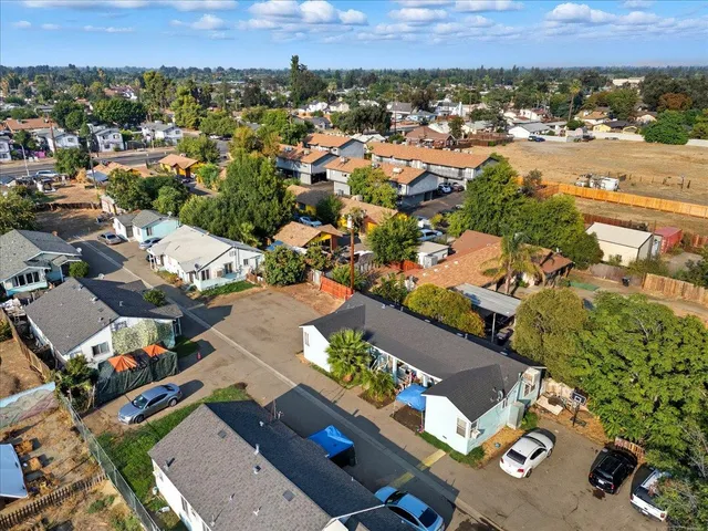 an aerial view of residential houses with outdoor space
