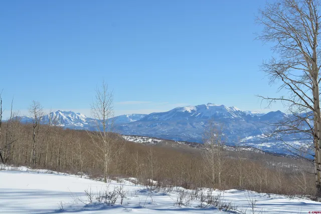 a view of a road with tall buildings in the background