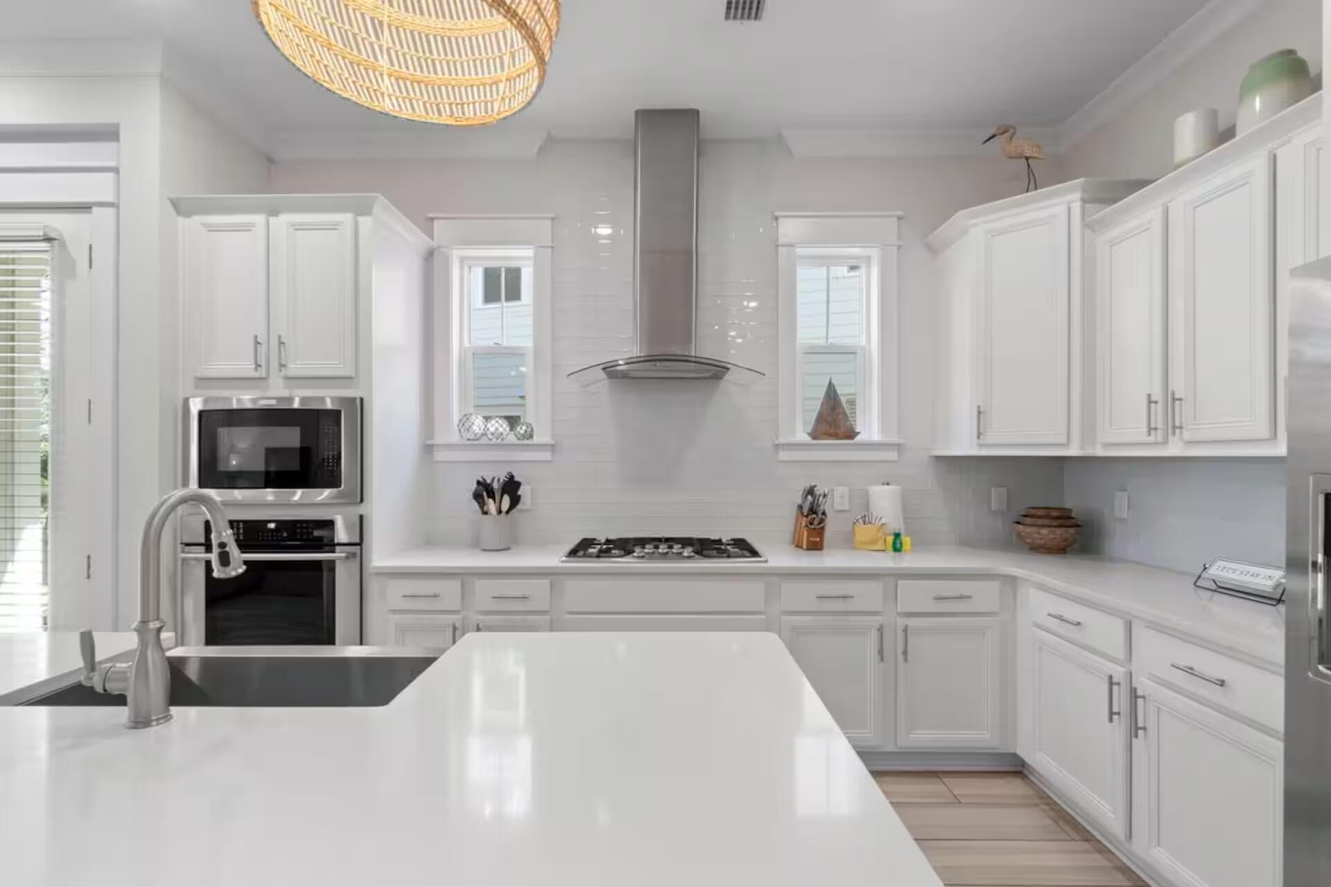 146 East E Pine, Unit B Inlet Beach, FL 32461 - Photo 14 of 47 a kitchen with white cabinets and appliances