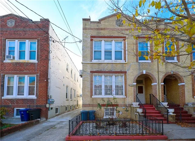 a front view of a building with outdoor seating