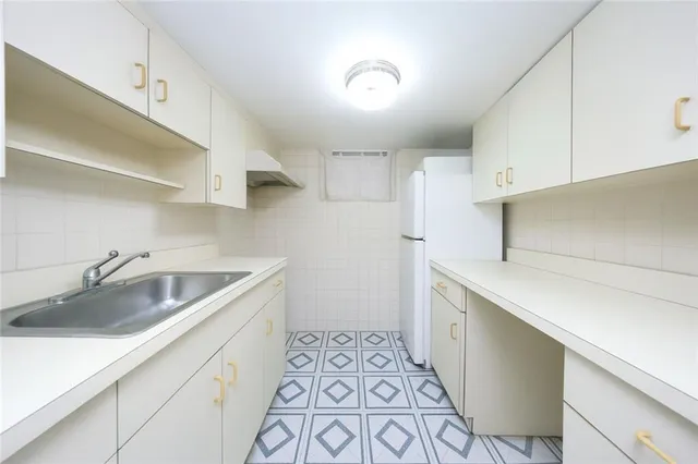 a kitchen with a sink and cabinets