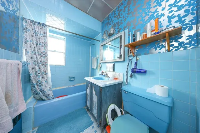 a bathroom with a sink a toilet and bathtub