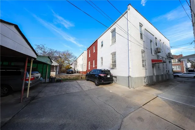a view of a car is parked in front of a building
