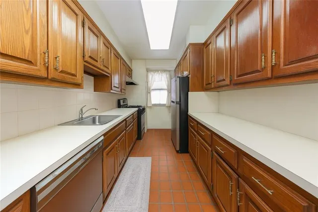 a kitchen with stainless steel appliances granite countertop a sink and cabinets