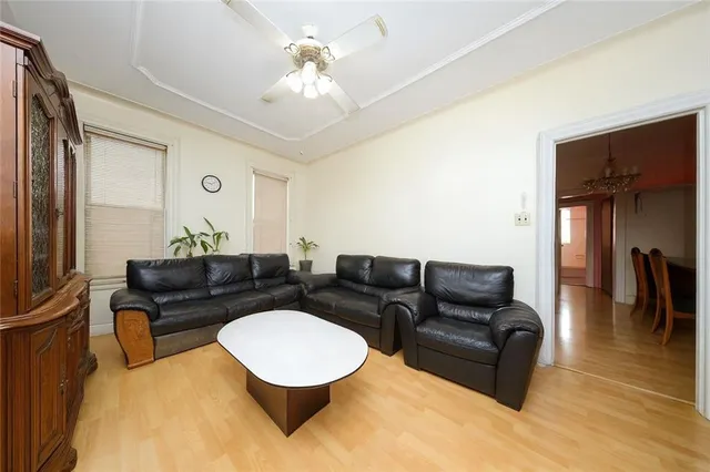 a living room with furniture and a dining table