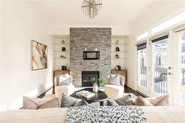 a living room with furniture a fireplace and a table
