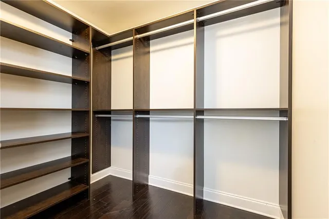 a view of walk in closet with empty racks