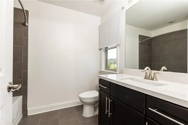 a bathroom with a sink a toilet and mirror
