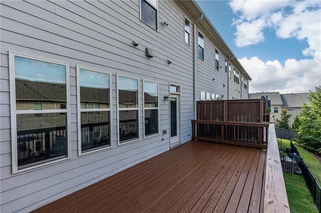 a view of a house with wooden deck