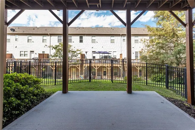 a view of a house with wooden fence