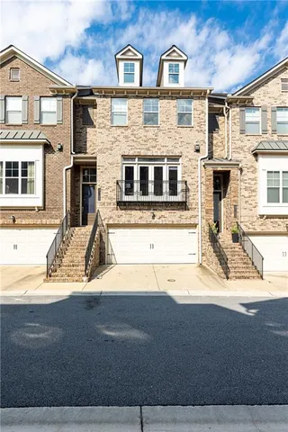 a view of a brick house with large windows