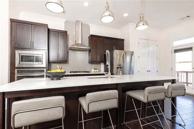 a kitchen with a table chairs refrigerator and microwave