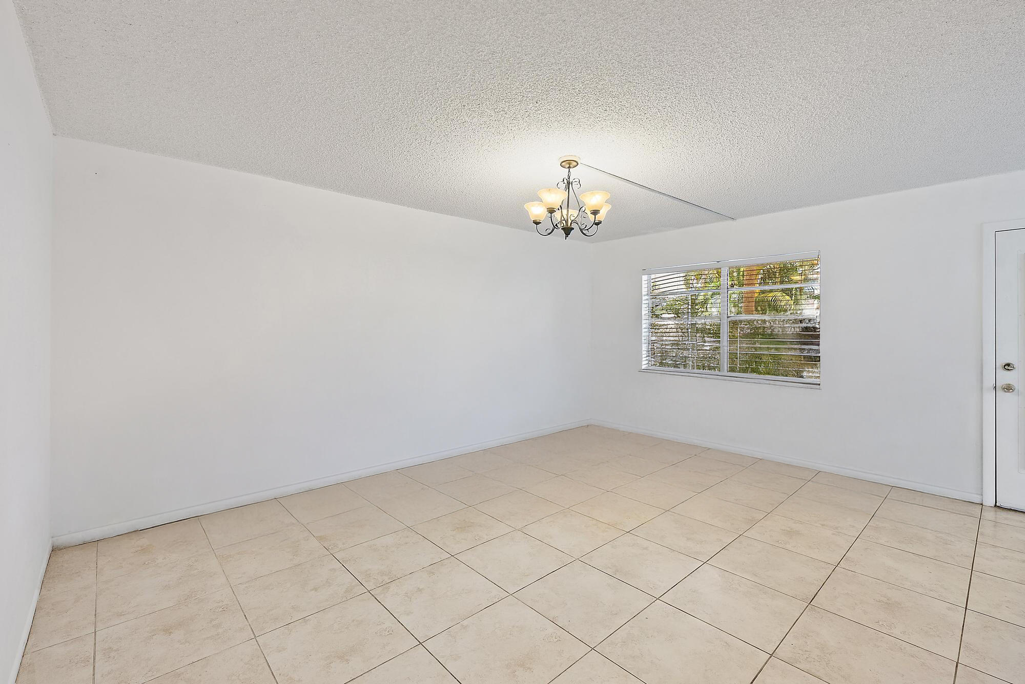 869 Flanders South Delray Beach, FL 33484 - Photo 3 of 13 an empty room with windows