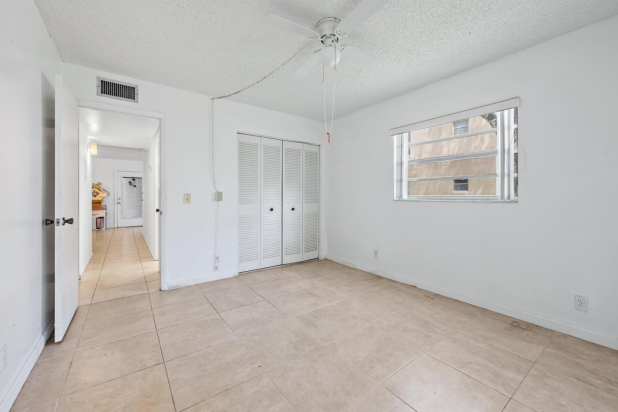 869 Flanders South Delray Beach, FL 33484 - Photo 6 of 13 wooden floor in an empty room