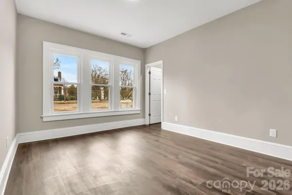 a view of an empty room and wooden floor