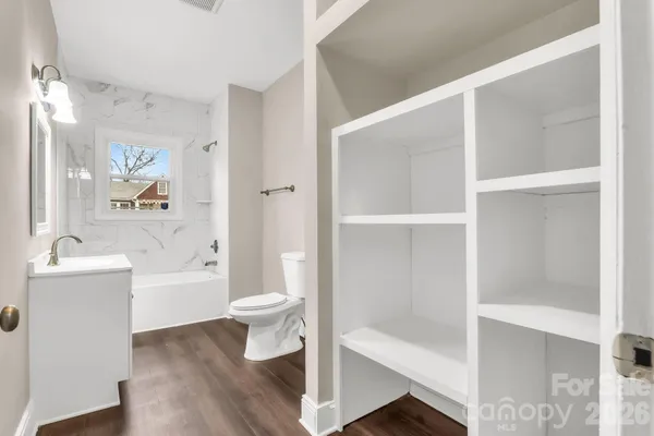 a bathroom with a bathtub and a toilet