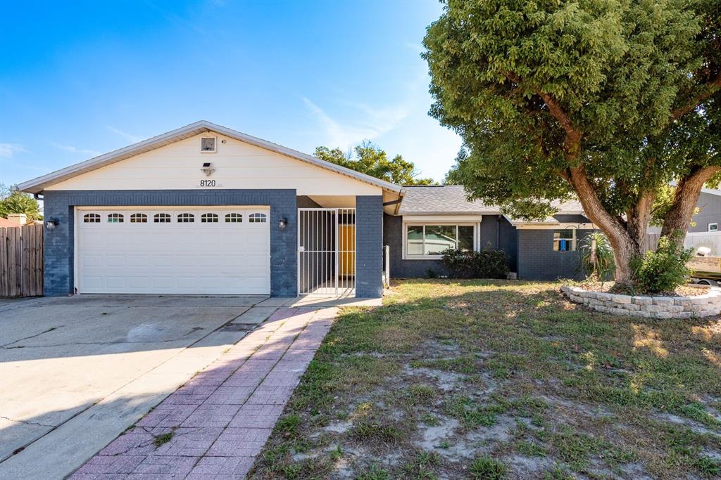 8120 Buttonball Lane Port Richey, FL 34668 - Photo 1 of 1 a front view of a house with a yard