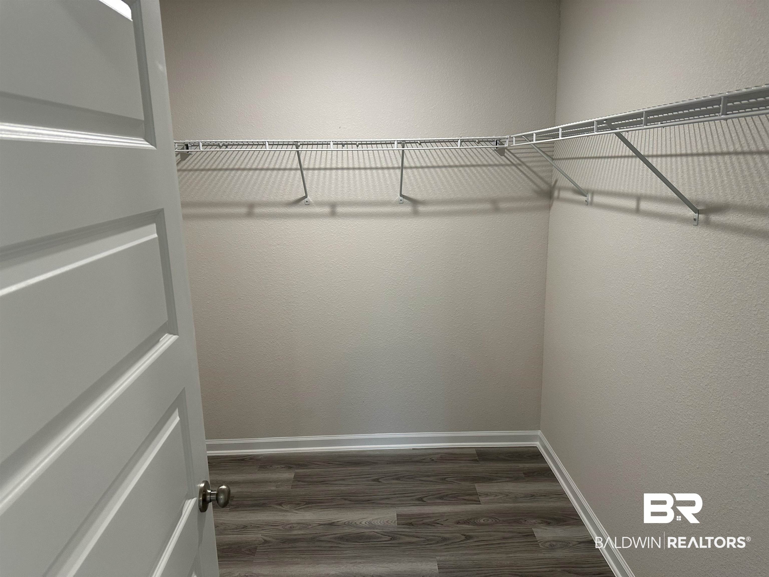 1238 Hayward Loop Foley, AL 36535 - Photo 35 of 46 Walk in closet with dark hardwood / wood-style floors