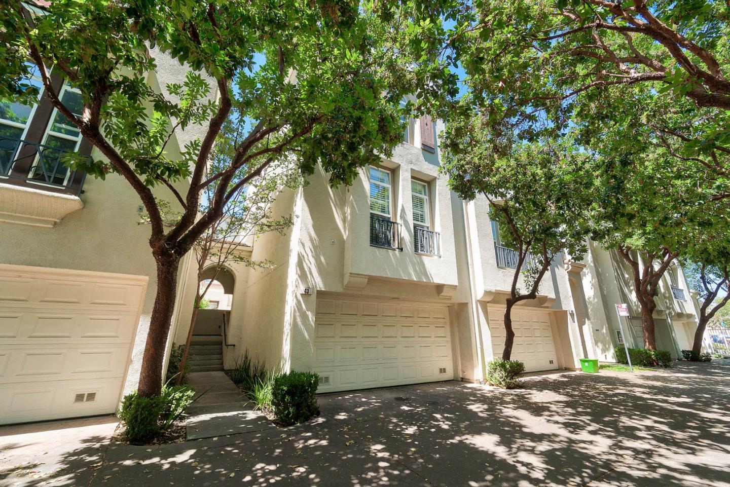 a front view of a house with a tree