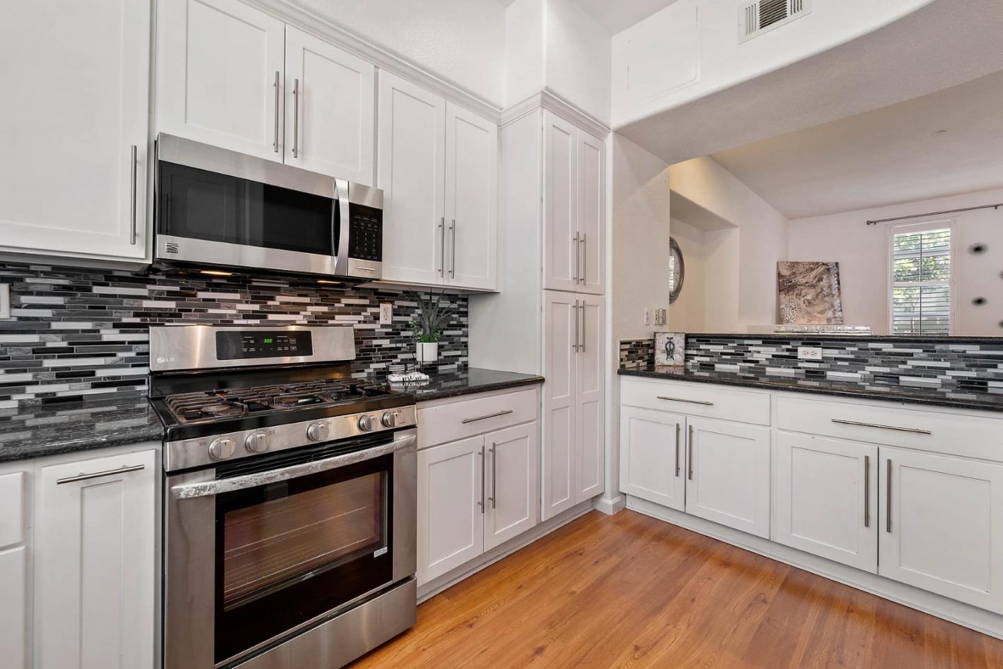 43 Rain Walk Milpitas, CA 95035 - Photo 11 of 48 a kitchen with stainless steel appliances granite countertop a stove and a microwave