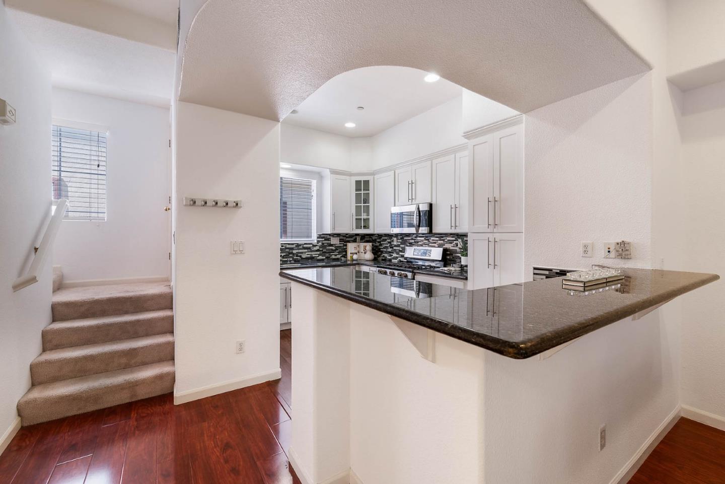 43 Rain Walk Milpitas, CA 95035 - Photo 14 of 48 a kitchen with a sink and wooden floor