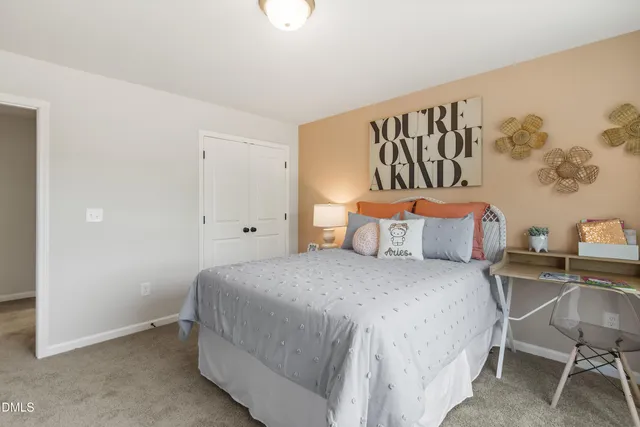 a bedroom with a bed and a table in it