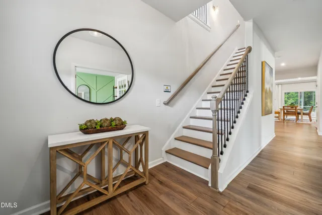 wooden floor with a table and white walls
