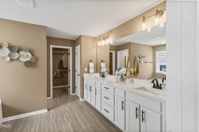 a spacious bedroom with a bed and a window