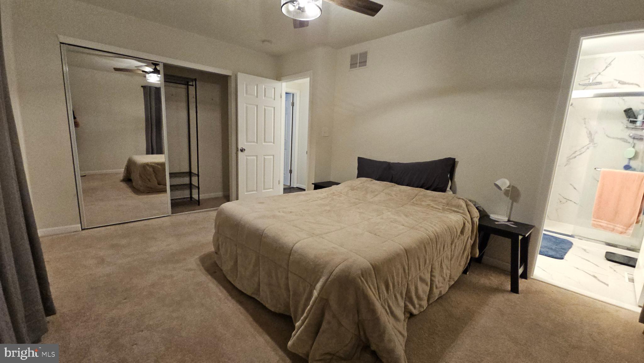 809 Duvall Highway Pasadena, MD 21122 - Photo 15 of 38 a bedroom with a bed and a chandelier