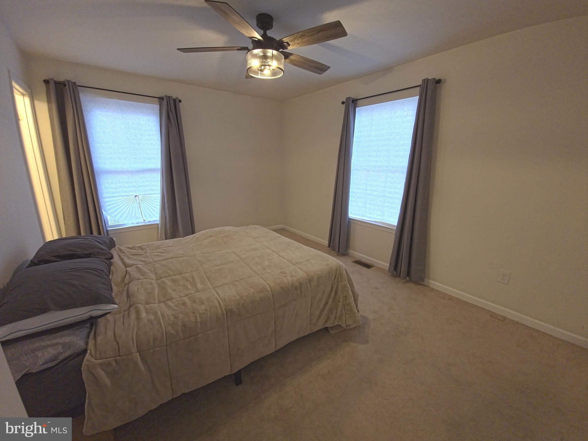 809 Duvall Highway Pasadena, MD 21122 - Photo 16 of 38 a bedroom with a bed and a chandelier