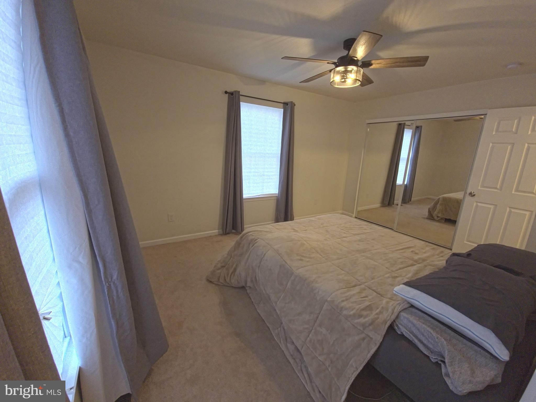 809 Duvall Highway Pasadena, MD 21122 - Photo 17 of 38 a bedroom with a large bed and a chandelier