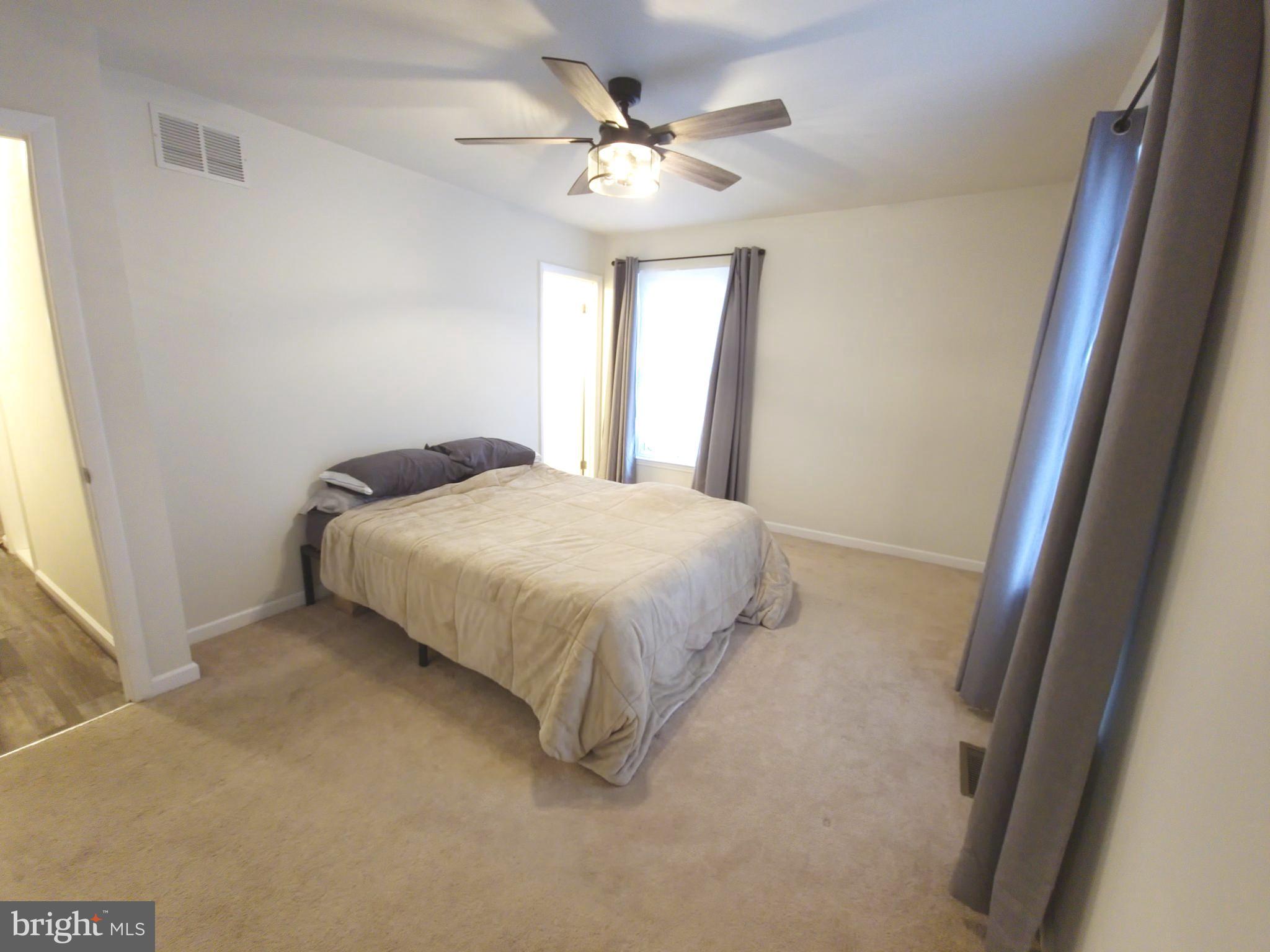 809 Duvall Highway Pasadena, MD 21122 - Photo 18 of 38 a bedroom with a bed and window