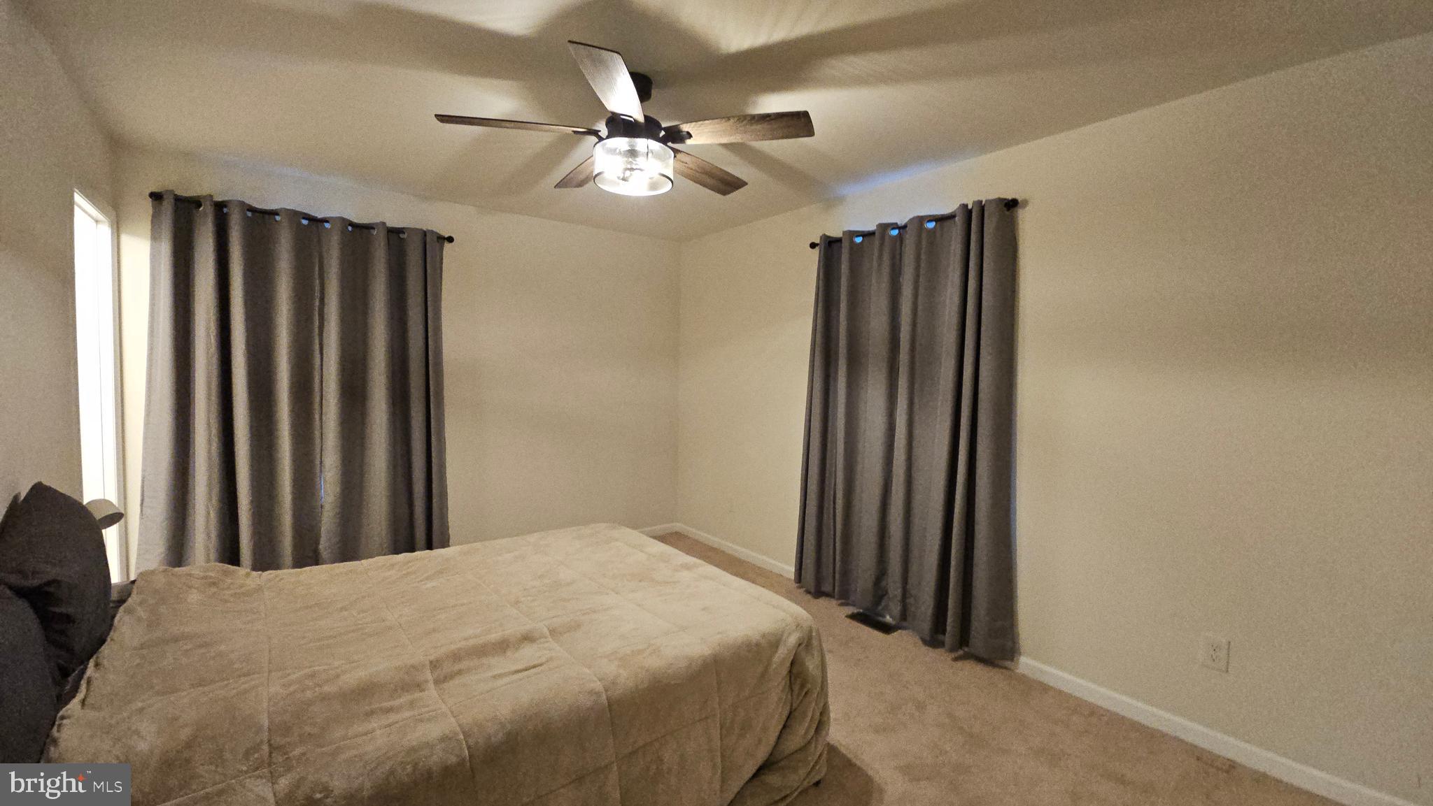 809 Duvall Highway Pasadena, MD 21122 - Photo 20 of 38 a bedroom with a large bed and a chandelier