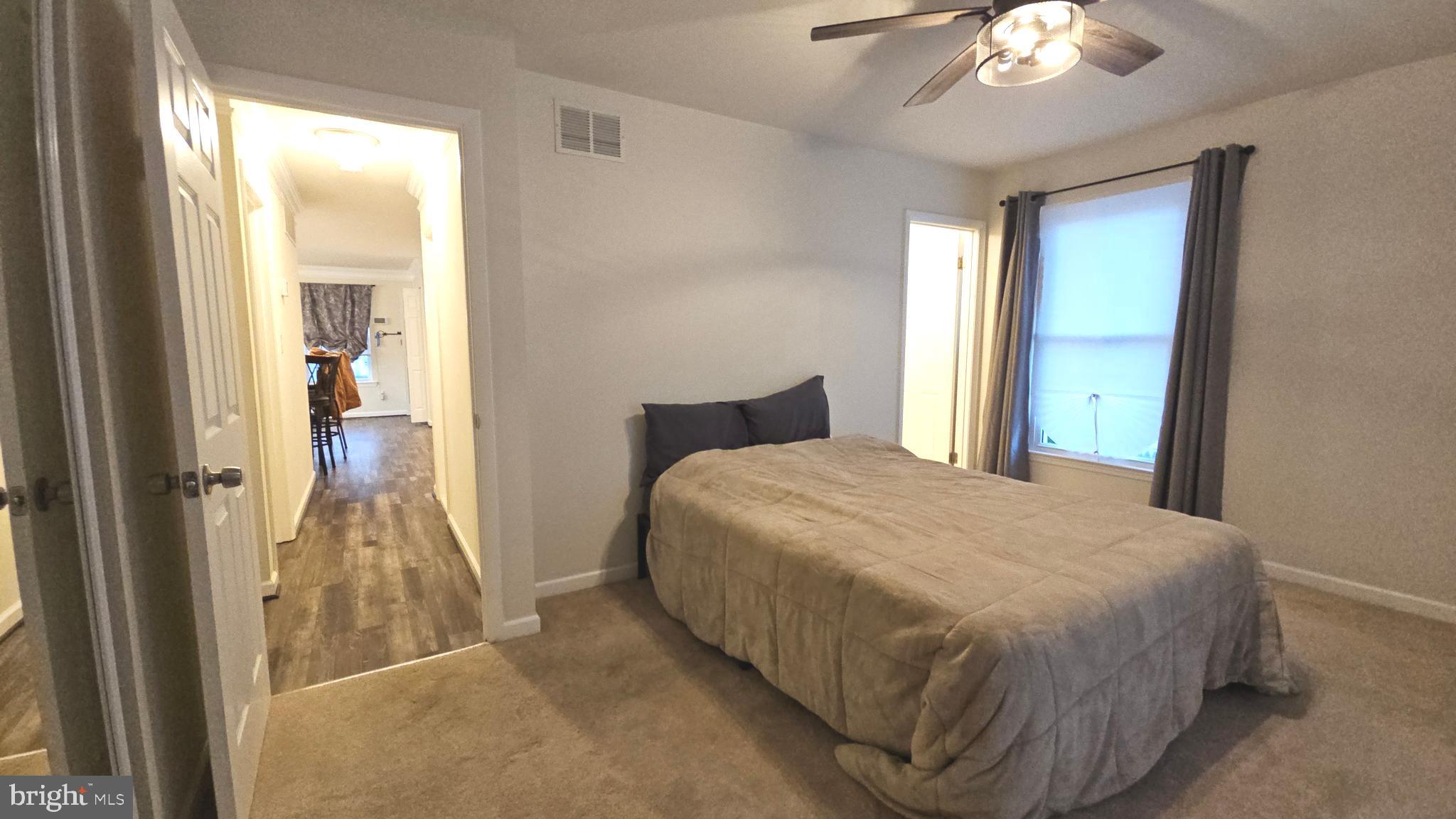 809 Duvall Highway Pasadena, MD 21122 - Photo 21 of 38 a bedroom with a bed and a chandelier