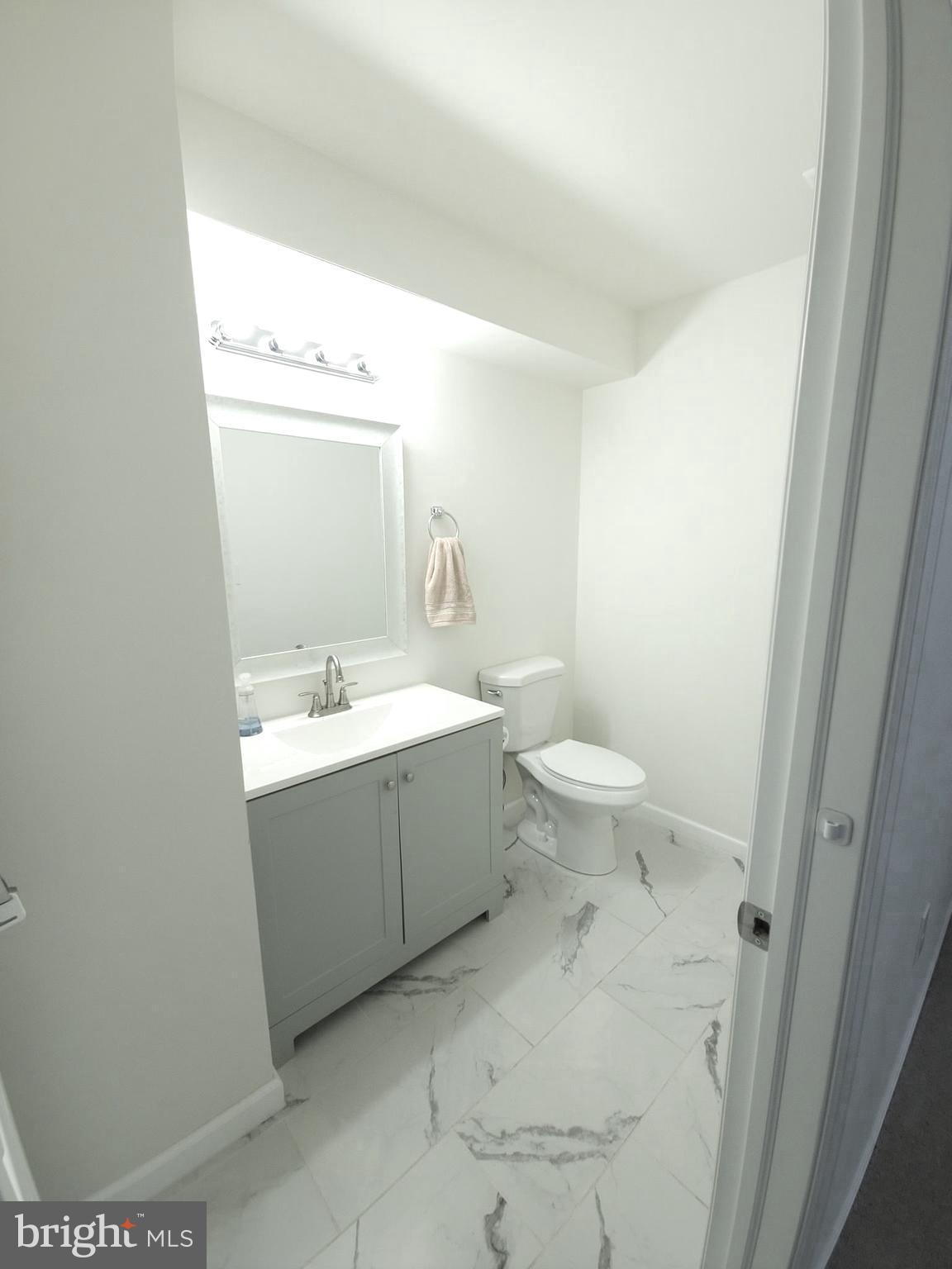 809 Duvall Highway Pasadena, MD 21122 - Photo 31 of 38 a bathroom with a sink mirror vanity and toilet