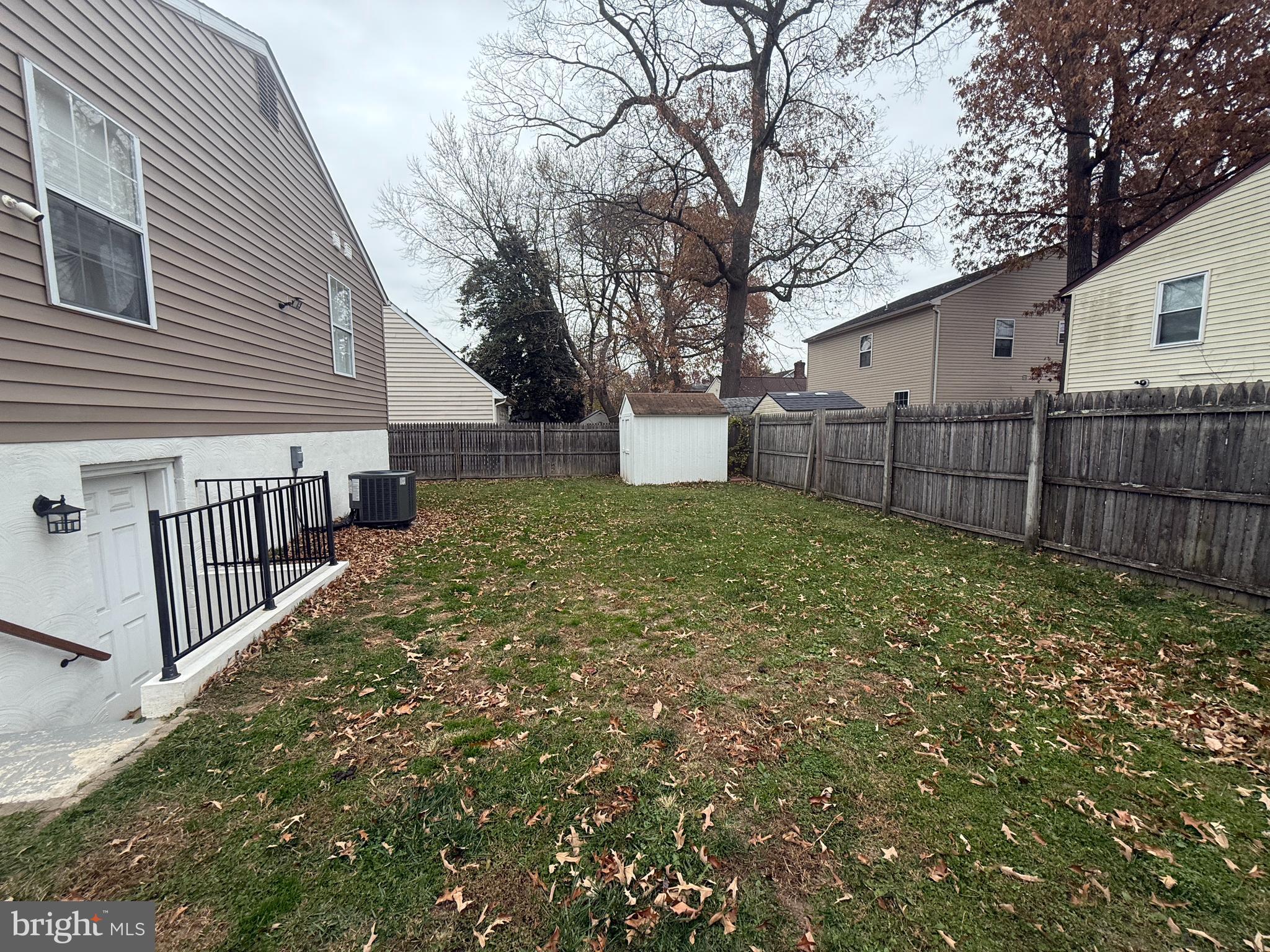 809 Duvall Highway Pasadena, MD 21122 - Photo 33 of 38 a view of a yard with wooden fence and trees