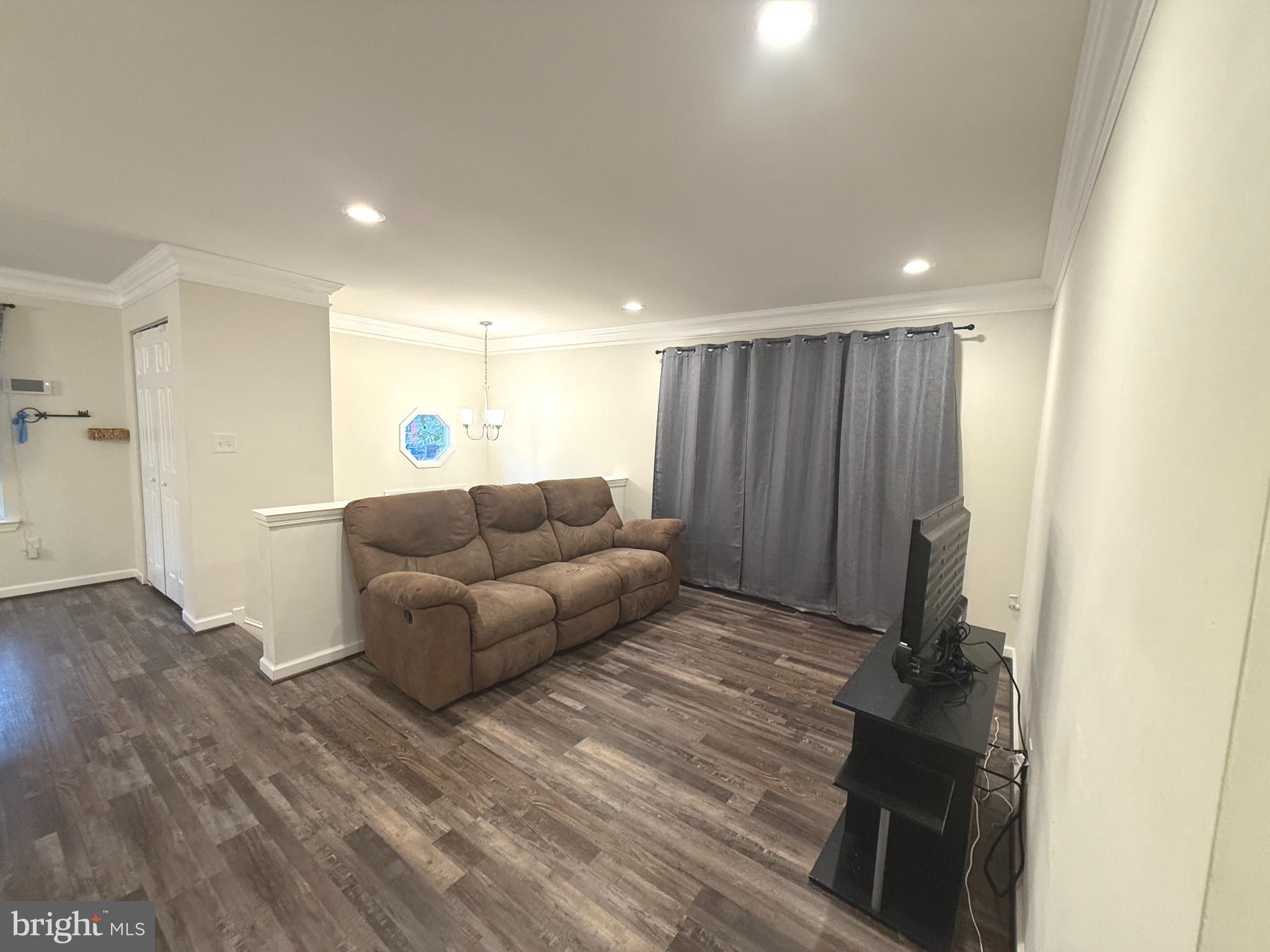 809 Duvall Highway Pasadena, MD 21122 - Photo 5 of 38 a living room with furniture and a wooden floor