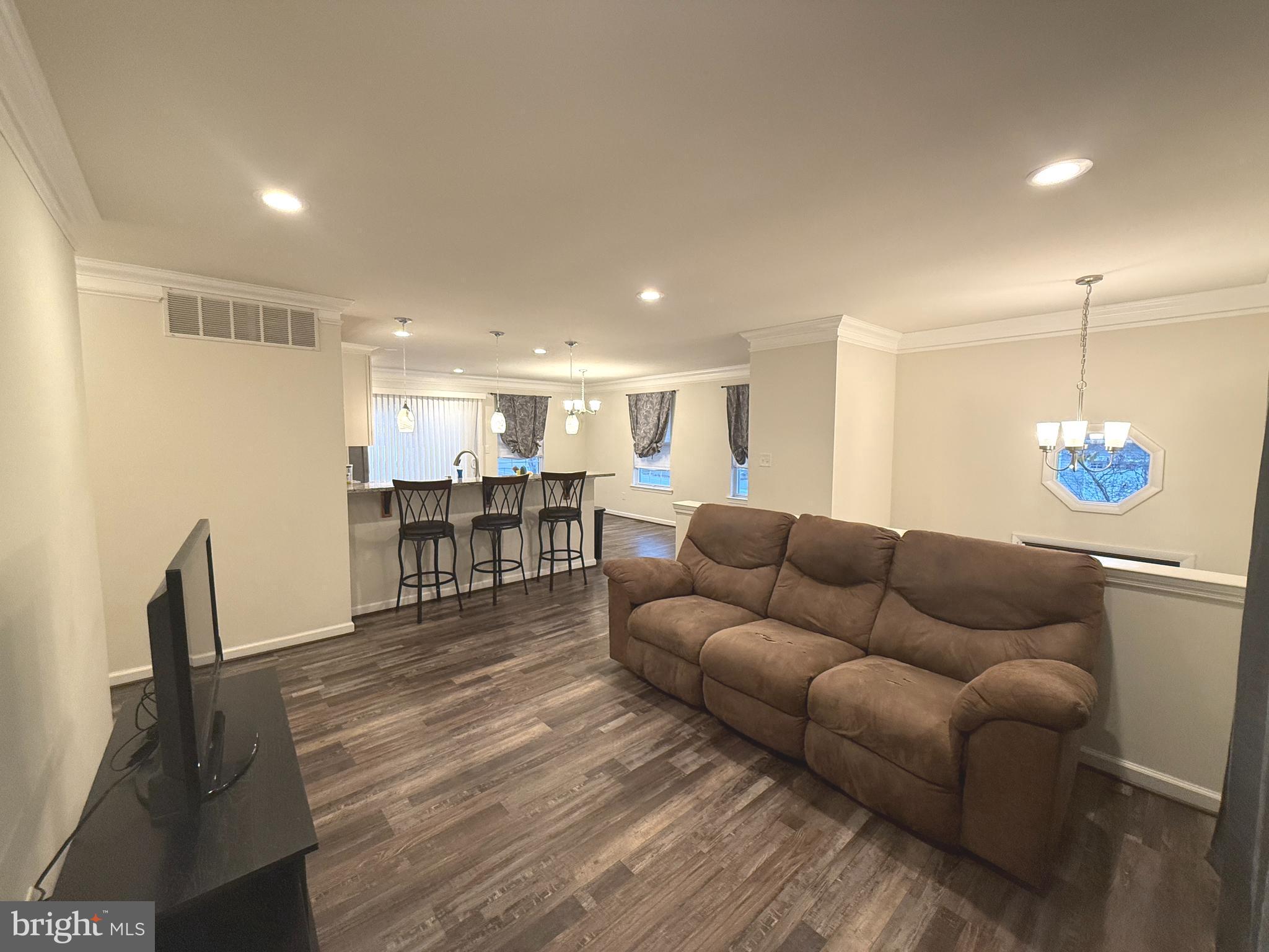 809 Duvall Highway Pasadena, MD 21122 - Photo 6 of 38 a living room with furniture and kitchen view