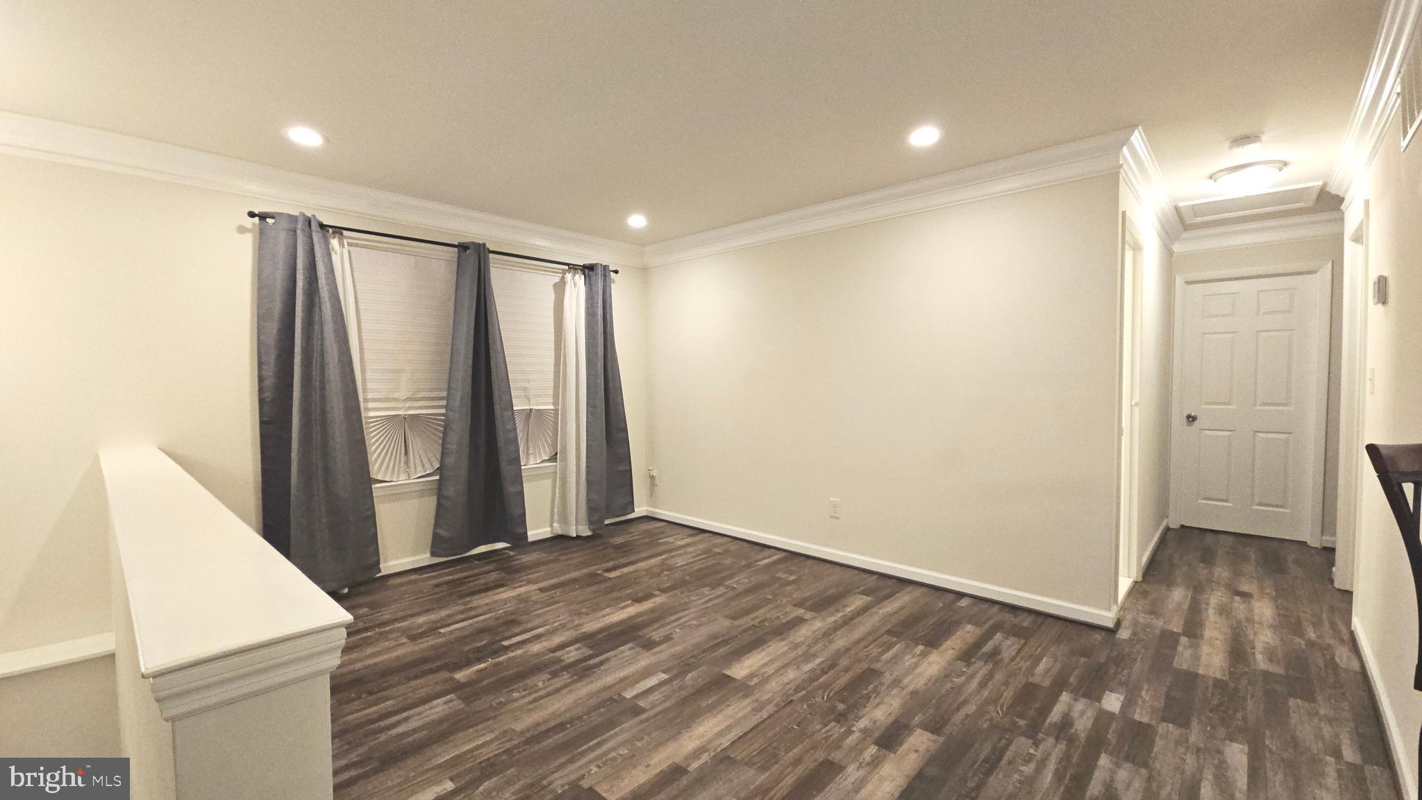 809 Duvall Highway Pasadena, MD 21122 - Photo 7 of 38 wooden floor in an empty room with a window