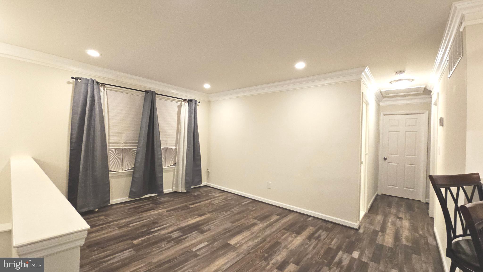 809 Duvall Highway Pasadena, MD 21122 - Photo 8 of 38 a view of a room with wooden floor and stairs