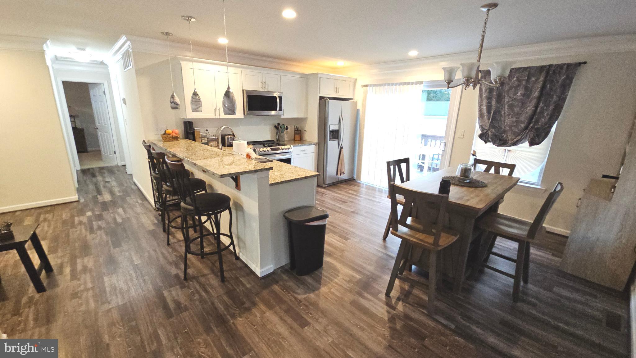 809 Duvall Highway Pasadena, MD 21122 - Photo 9 of 38 a view of a dining room with furniture window and wooden floor