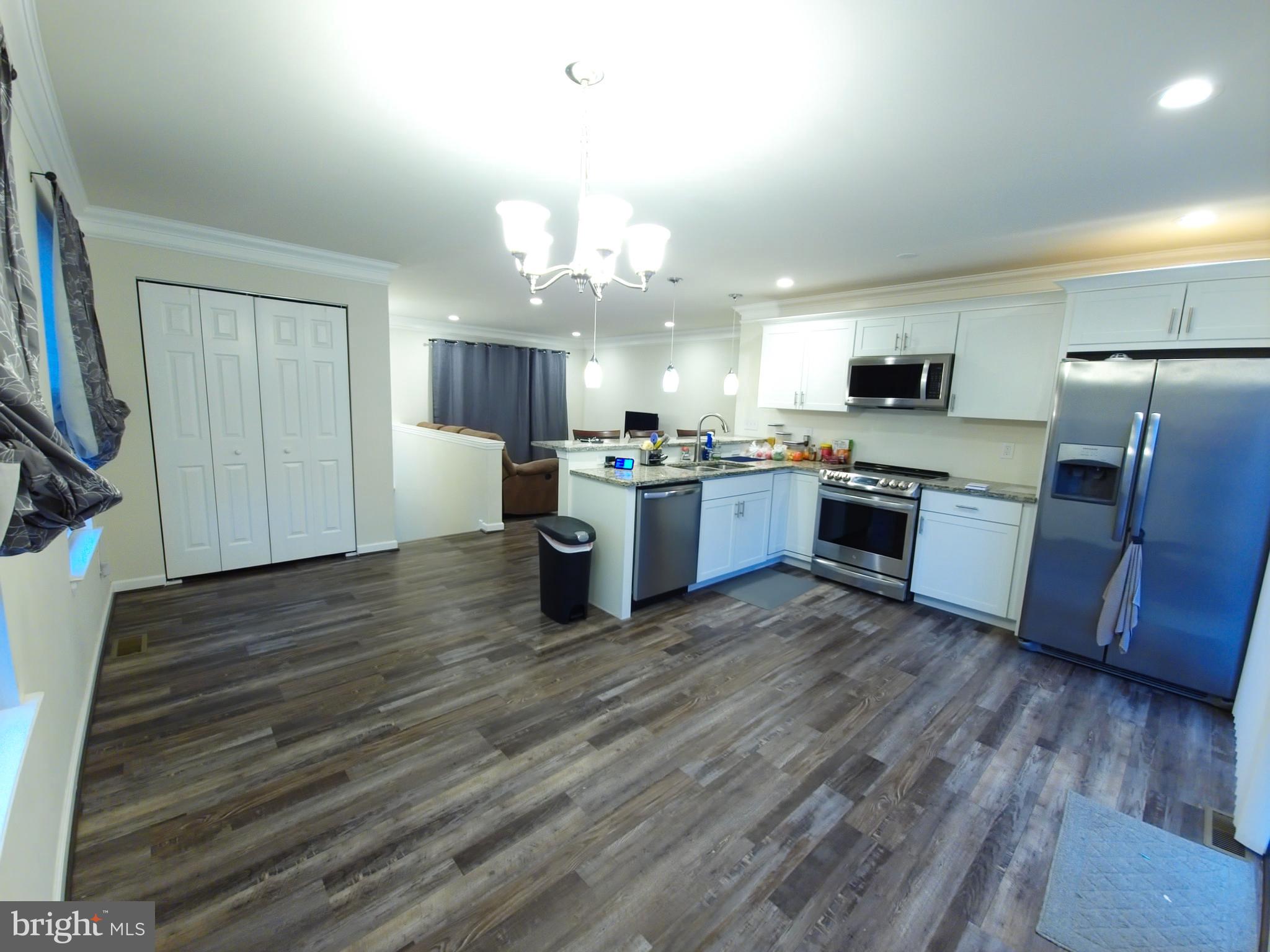 809 Duvall Highway Pasadena, MD 21122 - Photo 10 of 38 a kitchen with stainless steel appliances granite countertop wooden cabinets a refrigerator a stove a sink and a oven